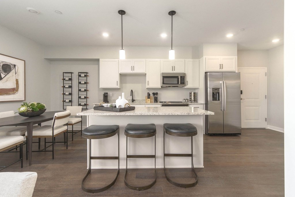 a large kitchen with a center island with three stools